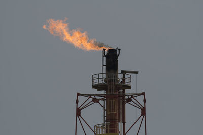 Low angle view of smoke stack against sky