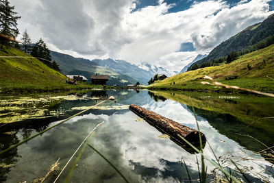 Scenic view of lake and mountains against sky