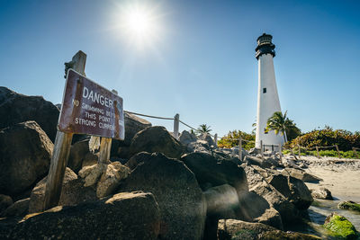 Information sign on rock against sky