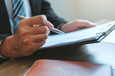 Close-up of man hand holding book