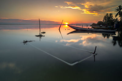 Scenic view of lake against sky during sunset