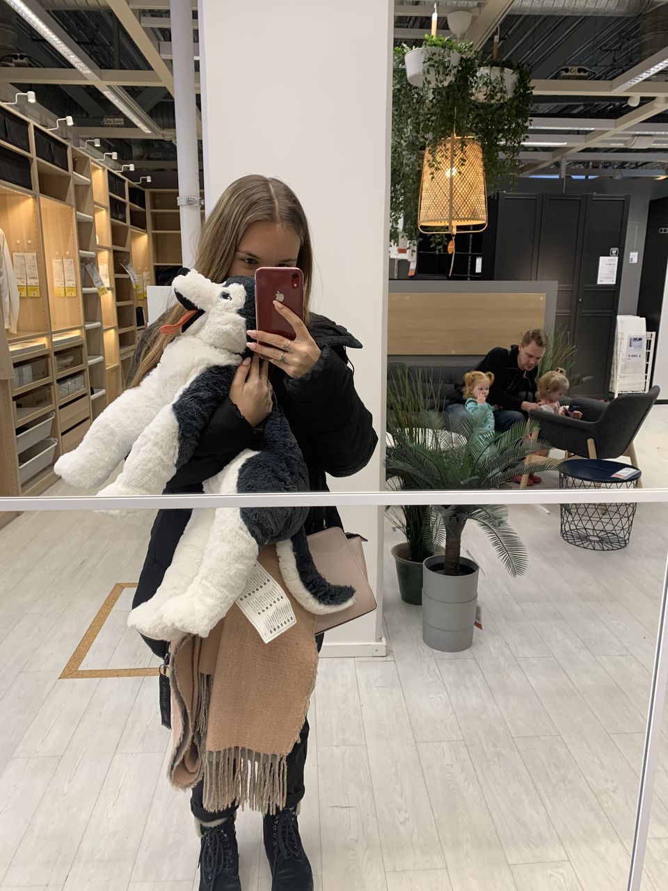 WOMAN PHOTOGRAPHING WITH SMART PHONE IN MIRROR