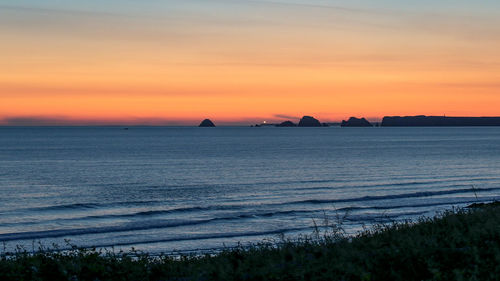Scenic view of sea against romantic sky at sunset