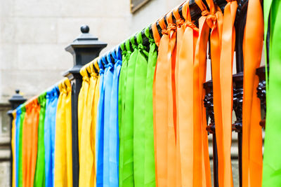 Multi colored clothes hanging on rack in store