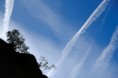Low angle view of vapor trail against blue sky