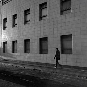 Full length of woman standing in front of building