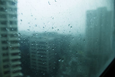 Full frame shot of wet glass window in rainy season