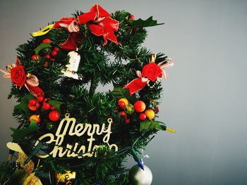 Close-up of red christmas decorations on plant