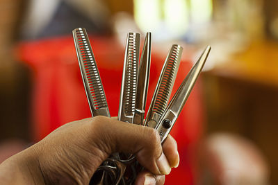 Close-up of hand holding scissors