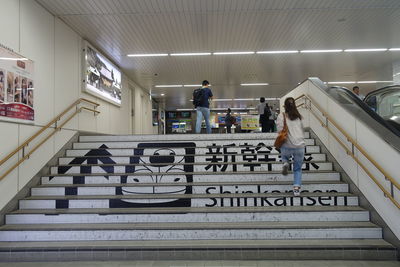 People standing on staircase in building