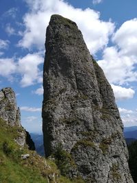 Low angle view of rock formations against sky