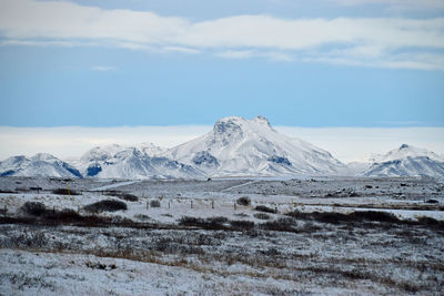 Scenic view of snowcapped mountains against sky