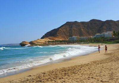 Scenic view of beach against blue sky