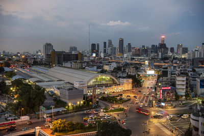 High angle view of illuminated cityscape against sky at night