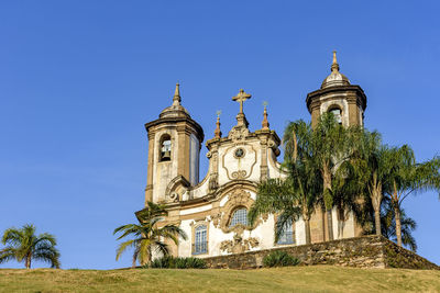 Low angle view of traditional building against clear blue sky