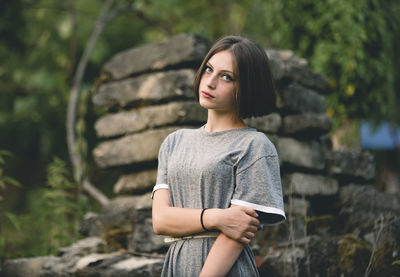 Portrait of young woman standing outdoors