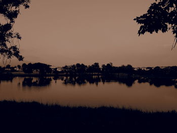 Scenic view of lake against sky at sunset