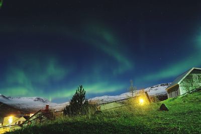 Scenic view of illuminated mountains against sky at night