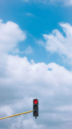 Low angle view of road sign against sky