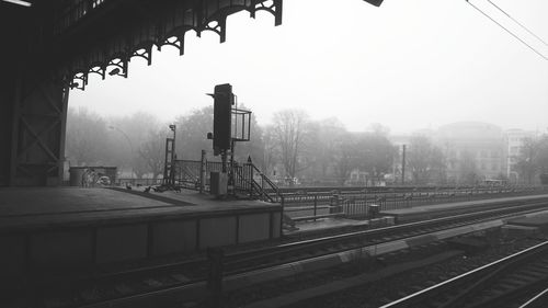 View of railroad station platform in foggy weather