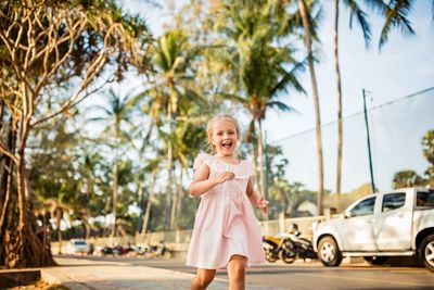 Cheerful girl running on road