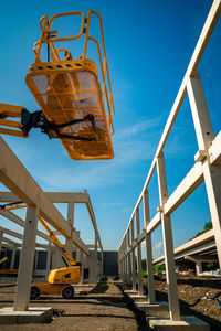 Low angle view of yellow bridge against sky