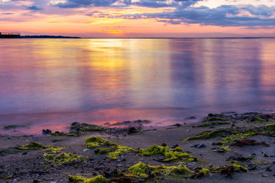 Scenic view of sea against sky at sunset