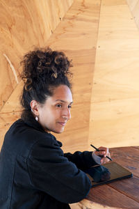 Woman using a digital tablet with an electronic pen.