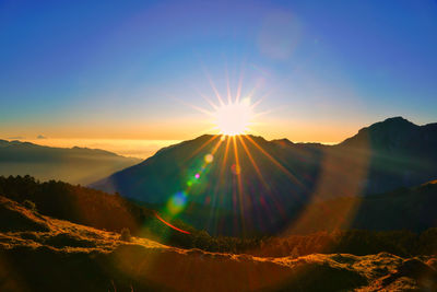 Scenic view of mountains against sky during sunset