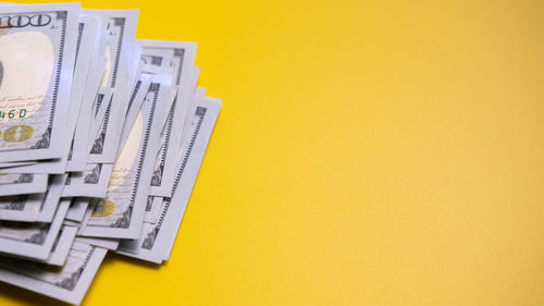 Close-up of computer keyboard on table against yellow background