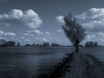 Scenic view of sea against cloudy sky