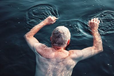 High angle view of man swimming in sea