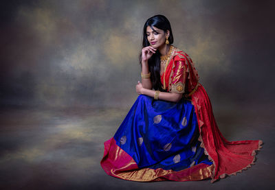 Woman standing against the wall