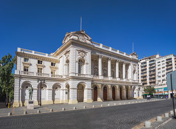 Low angle view of historic building against clear blue sky