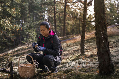 Young woman looking at camera in forest