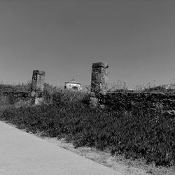 Abandoned built structure on field against clear sky