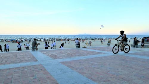 People on beach against sky