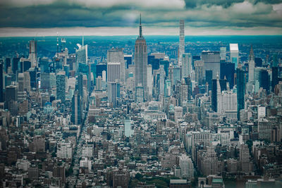 Aerial view of modern buildings in city against sky