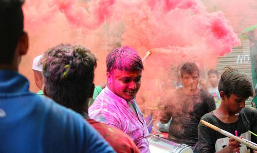 Portrait of a young man with multi colored people