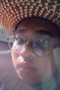 Close-up portrait of young man wearing eyeglasses