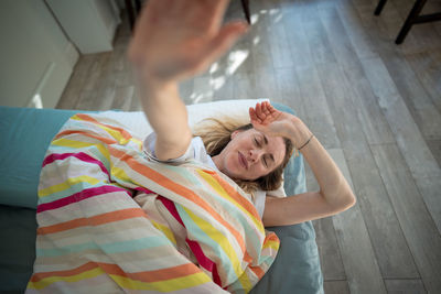 Rear view of man sitting on floor