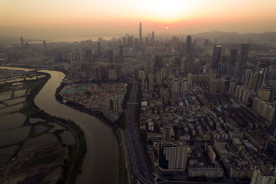 High angle view of buildings in city during sunset