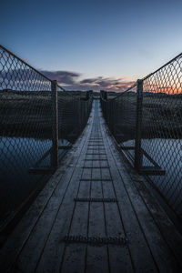 View of footbridge against sky during sunset