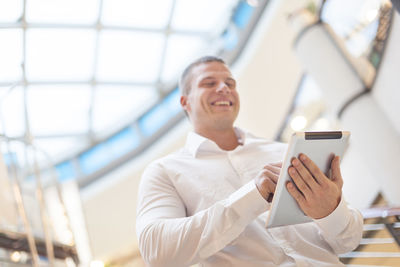Mid adult man using mobile phone