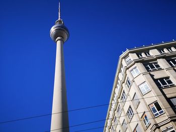 Low angle view of tower against blue sky