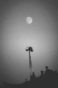 Low angle view of amusement park against sky