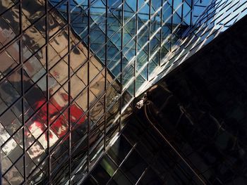 Low angle view of glass building against sky