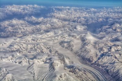 High angle view of snowcapped mountains against sky