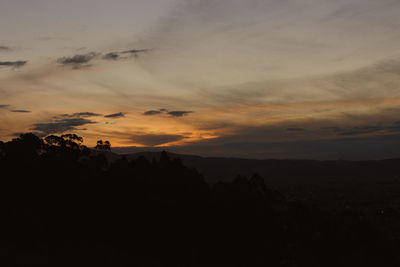 Scenic view of silhouette mountains against sky at sunset