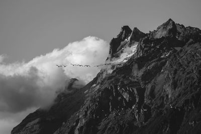 Low angle view of rocky mountains against sky